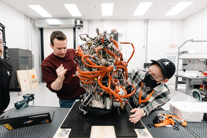 Keaton Roe, Engine Production Lead at Ursa Major, and Melissa Cornelius, Quality Control Manager at Astra, check out a Hadley engine at Ursa Major’s headquarters in Berthoud, Colorado.