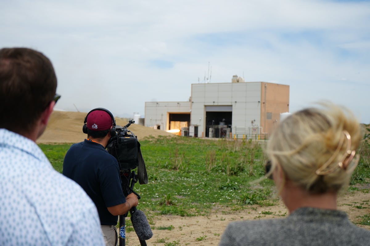 Michael Abeyta from CBS News Colorado films a hotfire test of Hadley while Ursa Major CEO & Founder Joe Laurienti and General Counsel Sarah Ramuta look on.