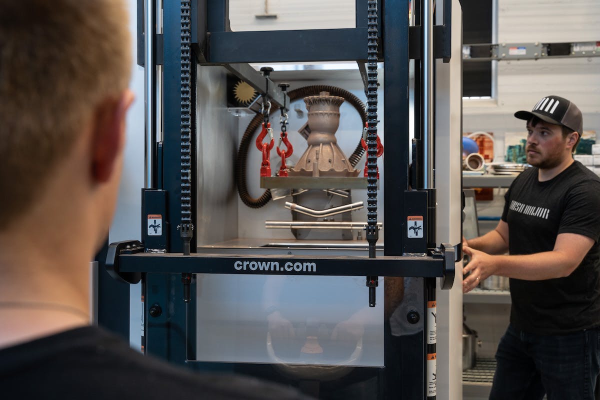 Ty Barzak and Thomas Pomorski remove a 3D-printed copper rocket engine component from the EOS 3D printer at rocket propulsion company Ursa Major’s Advanced Manufacturing Lab in Youngstown, Ohio. Ursa Major will use these components for hotfire testing at its headquarters in Berthoud, Colorado.